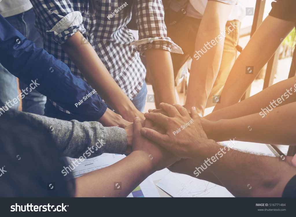people joining hands together